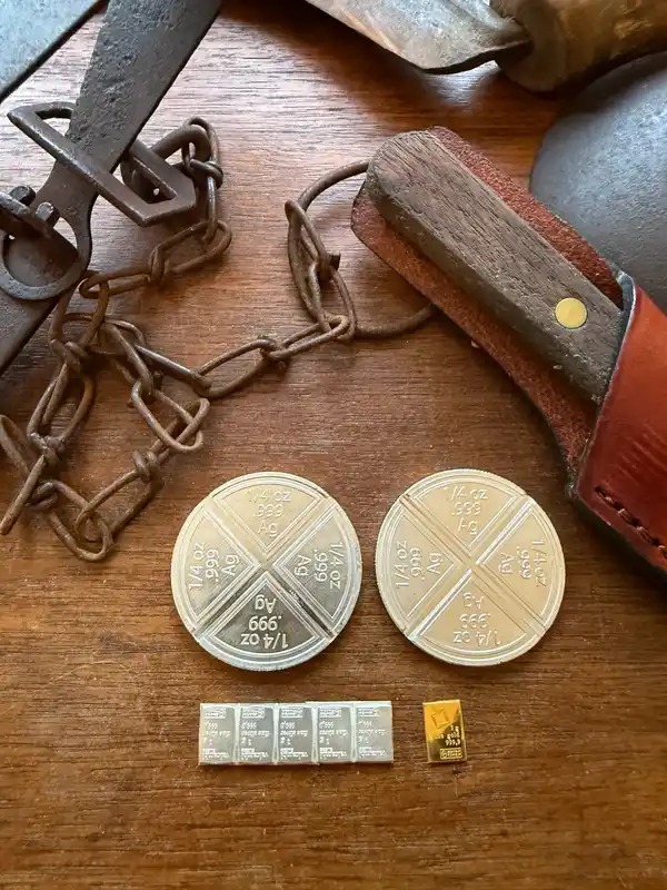 Coins and chains on a wooden surface.